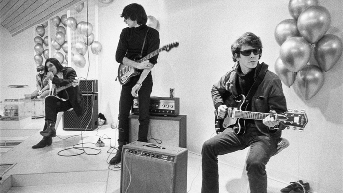 An image from The Velvet Underground showing the band members with their musical instruments
