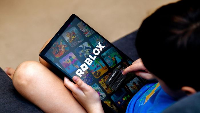 A child enjoying a game of Roblox on a tablet device.