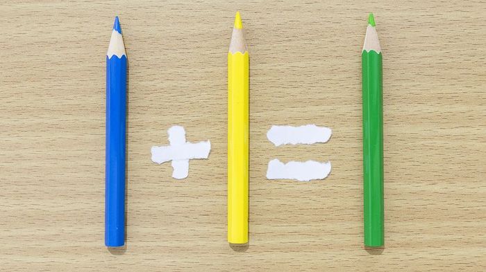 Colored pencils arranged to resemble a mathematical equation