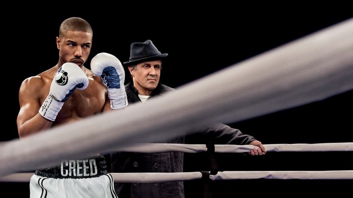 Adonis Creed and Rocky Balboa facing off in the ring from the movie 'Creed'