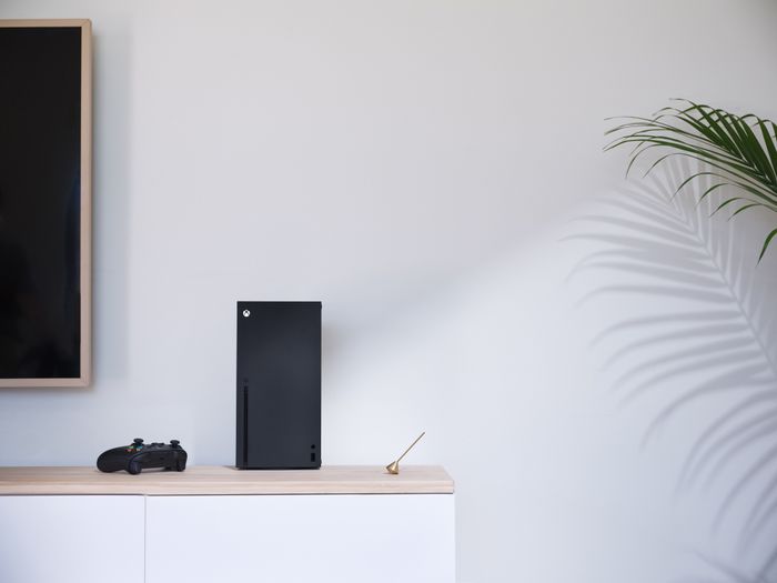 An Xbox Series X positioned on an entertainment center