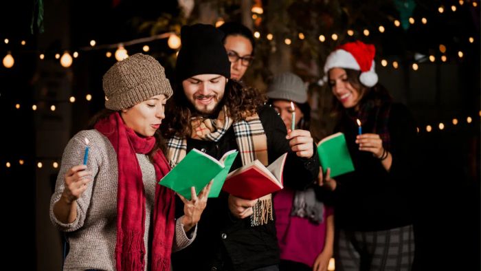 A group of carolers singing festive tunes outdoors under the evening sky