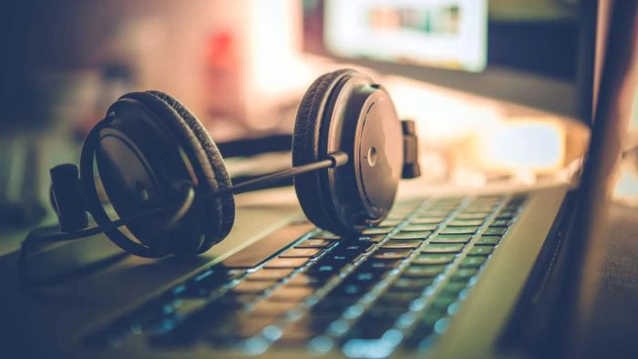 Headphones resting on a computer keyboard