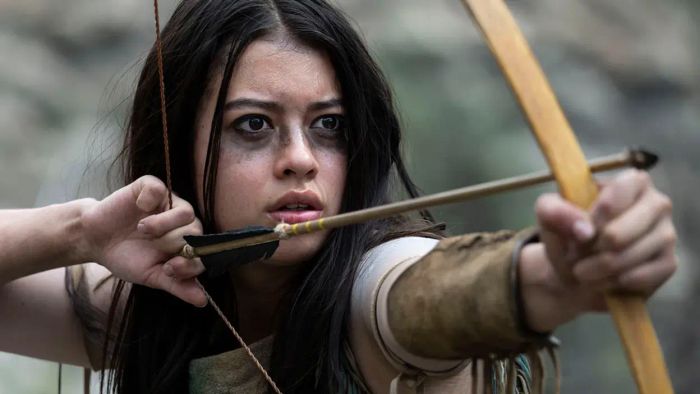 A Comanche woman wields a bow and arrow in a striking scene from Prey