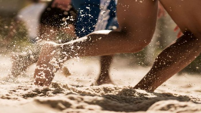 Running barefoot on sandy terrain