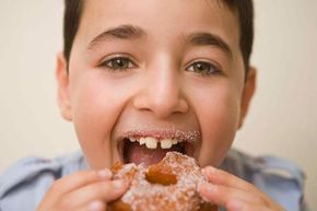 a boy enjoying a donut