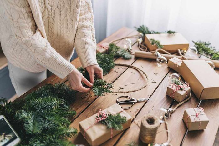 A woman crafting her own Christmas wreath.