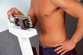 A man stepping on a digital weighing scale