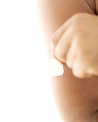 A nicotine patch applied to an arm