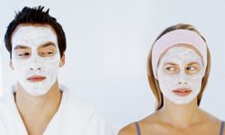 a man and woman applying facial beauty masks