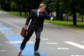 a professional man rollerblading in formal attire