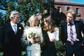 Four elegant, affluent characters from the TV series 'Dynasty' are shown preparing for a wedding.
