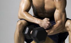 a muscular weightlifter in a seated position