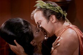A man and woman share a deeply emotional kiss.