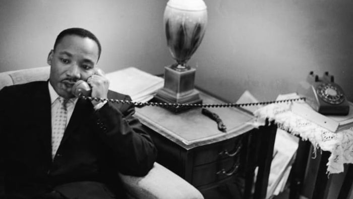 Dr. Martin Luther King Jr. is seen engaged in a phone conversation.