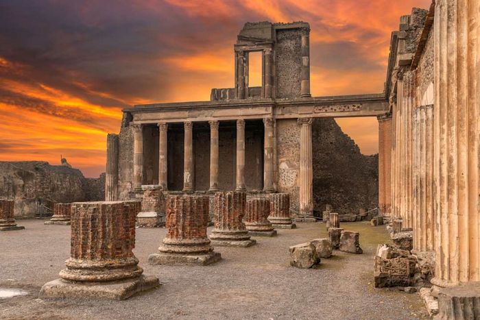 The ancient Roman basilica ruins in Pompeii at sunset.