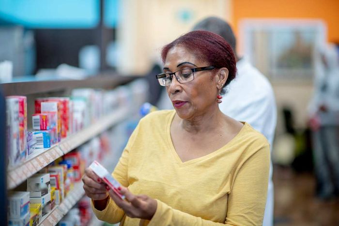 A woman shopping for over-the-counter medications.