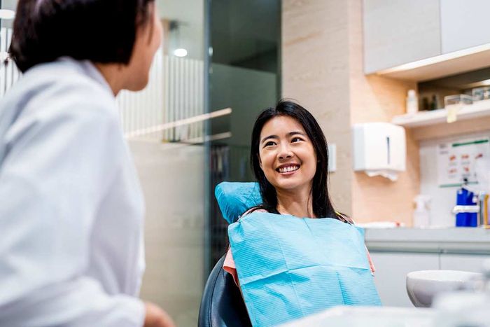 A woman smiling at her dentist.