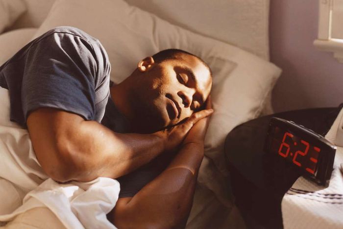 A man sleeping in his bed.