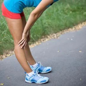 A female runner experiencing a side stitch.