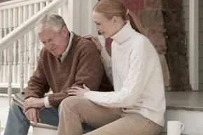 A father and daughter share a quiet moment together on the steps.