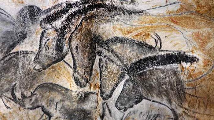 A precise reproduction of select Chauvet Cave illustrations, featuring a group of four horses and a woolly rhinoceros.