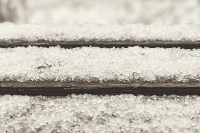 Snow and hail covering wooden steps