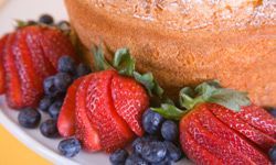 Enhance your dessert with fresh strawberries and blueberries paired with angel food cake for a vibrant and nutritious treat.