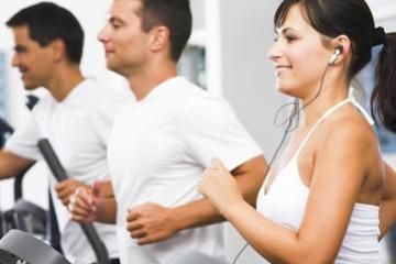 joyful individuals jogging on treadmill machines