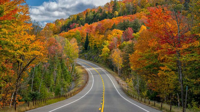 This breathtaking view near Saranac Lake in the Adirondacks perfectly captures why New York stands as the premier state for autumn road trips.