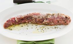 Pork chop on a plate seasoned with herbs