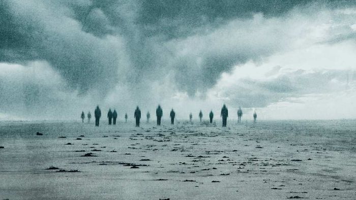 A spectral phenomenon. A cluster of indistinct lost souls strolling along a beach on a gloomy day, enhanced with an abstract, grunge-style edit.