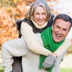 man carrying woman on his back
