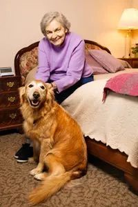 A nursing home resident spending time with a dog