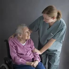An elderly woman with her caregiver