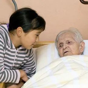 A child visiting their grandparent in a nursing home