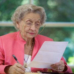 elderly woman reviewing contracts