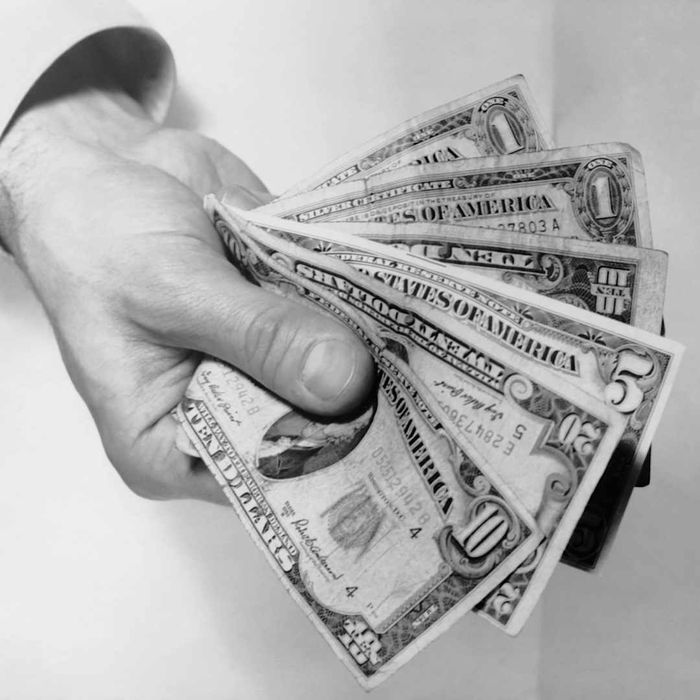 photo of a hand fanning out u.s. dollars