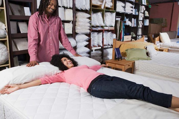 A couple shopping for beds.