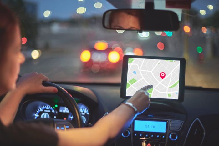 A woman navigating with GPS in her vehicle.