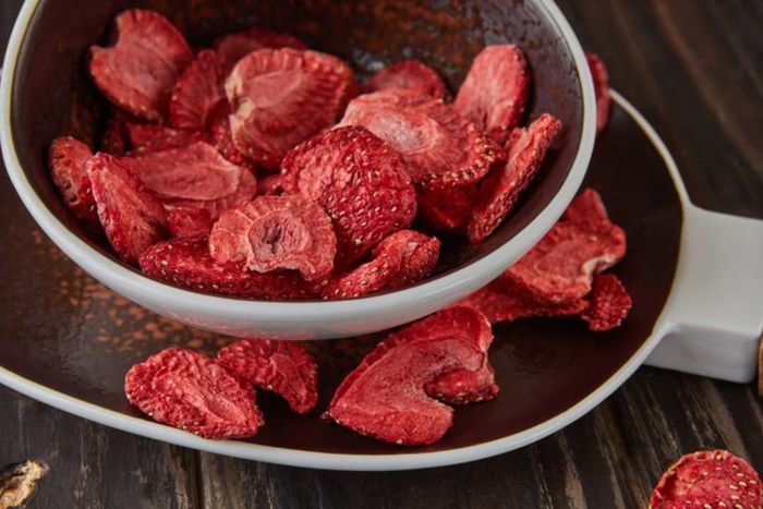 A bowl filled with freeze-dried strawberries.