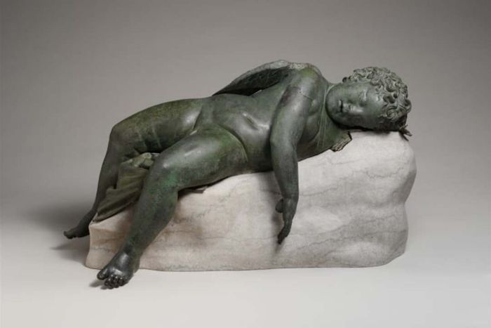 A bronze statue from ancient Greece depicting Eros in slumber, similar to those that may have influenced Michelangelo
