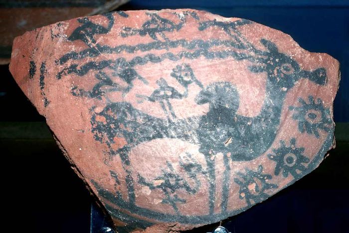 A pottery fragment featuring a painted humped bull and birds from the Indus Valley, dating back to around 2600 BCE.