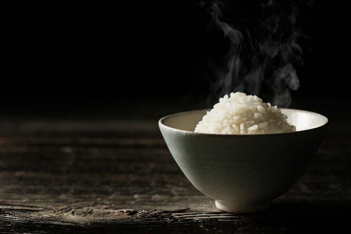 A bowl of rice placed on a wooden table