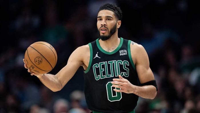 Jayson Tatum gripping a basketball during a game