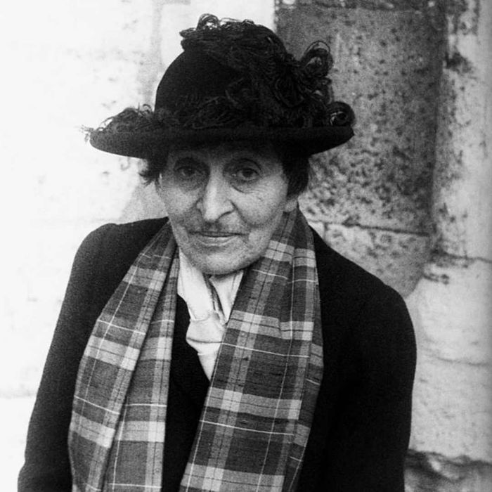A 1949 photograph of Alice B. Toklas wearing a black hat and plaid scarf