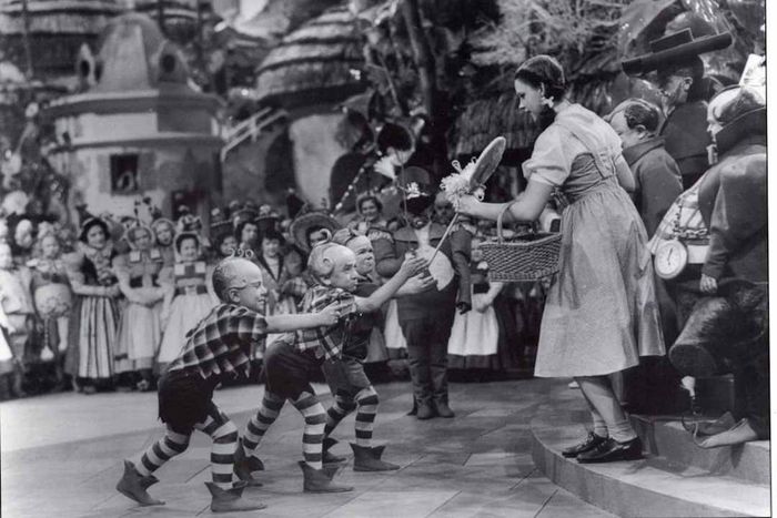 Jerry Maren hands Judy Garland a lollipop in the movie
