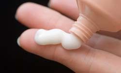 Cream on woman's hands.