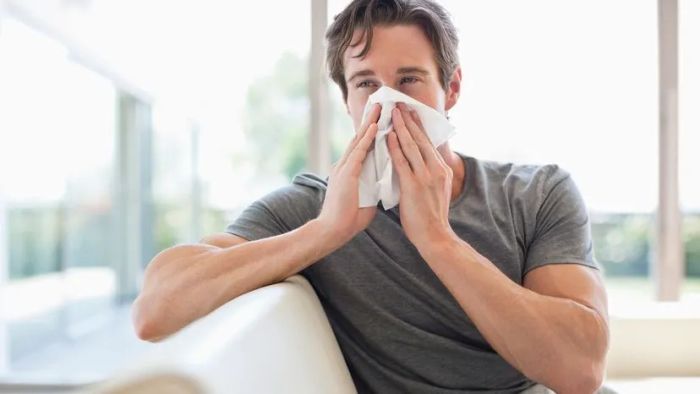 person with tissues in hand