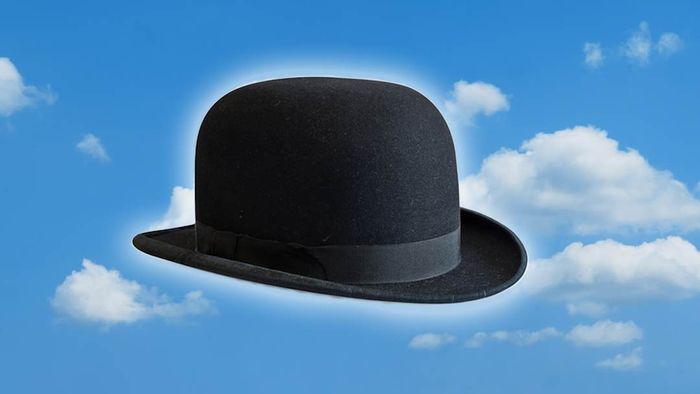 A bowler hat set against a backdrop of blue sky and clouds
